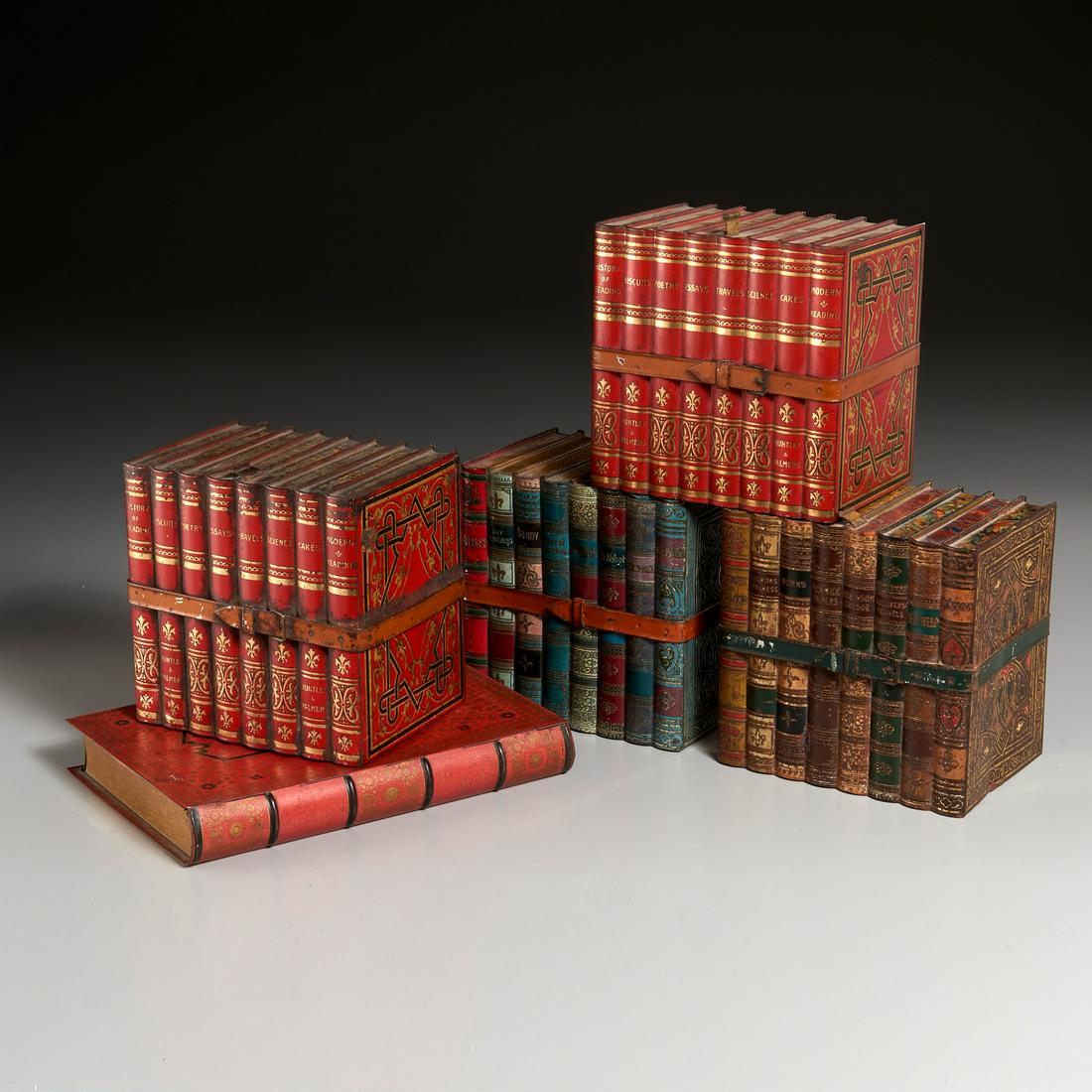 (5) English Lithographed Tin Biscuit Boxes: (5) English Lithographed Tin Biscuit Boxes, Early 20th c., all for Huntley & Palmer, including a pair as leather-strapped red bound books, a pair as strapped group of multicolor books, and one tin as 