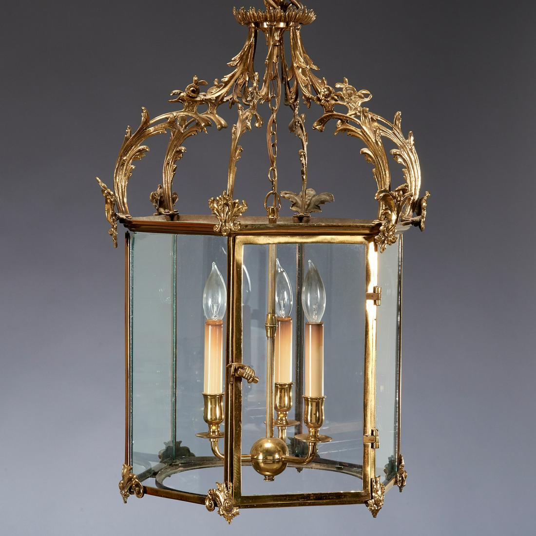 George III Hexagonal Brass Hall Lantern: George III Hexagonal Brass Hall Lantern, Late 18th c., embellished with acanthus scrolls and enclosing a three-light fixture, 30 1/2" h x 14" dia Provenance: The Collection of Elizabeth "Betty" Seeler