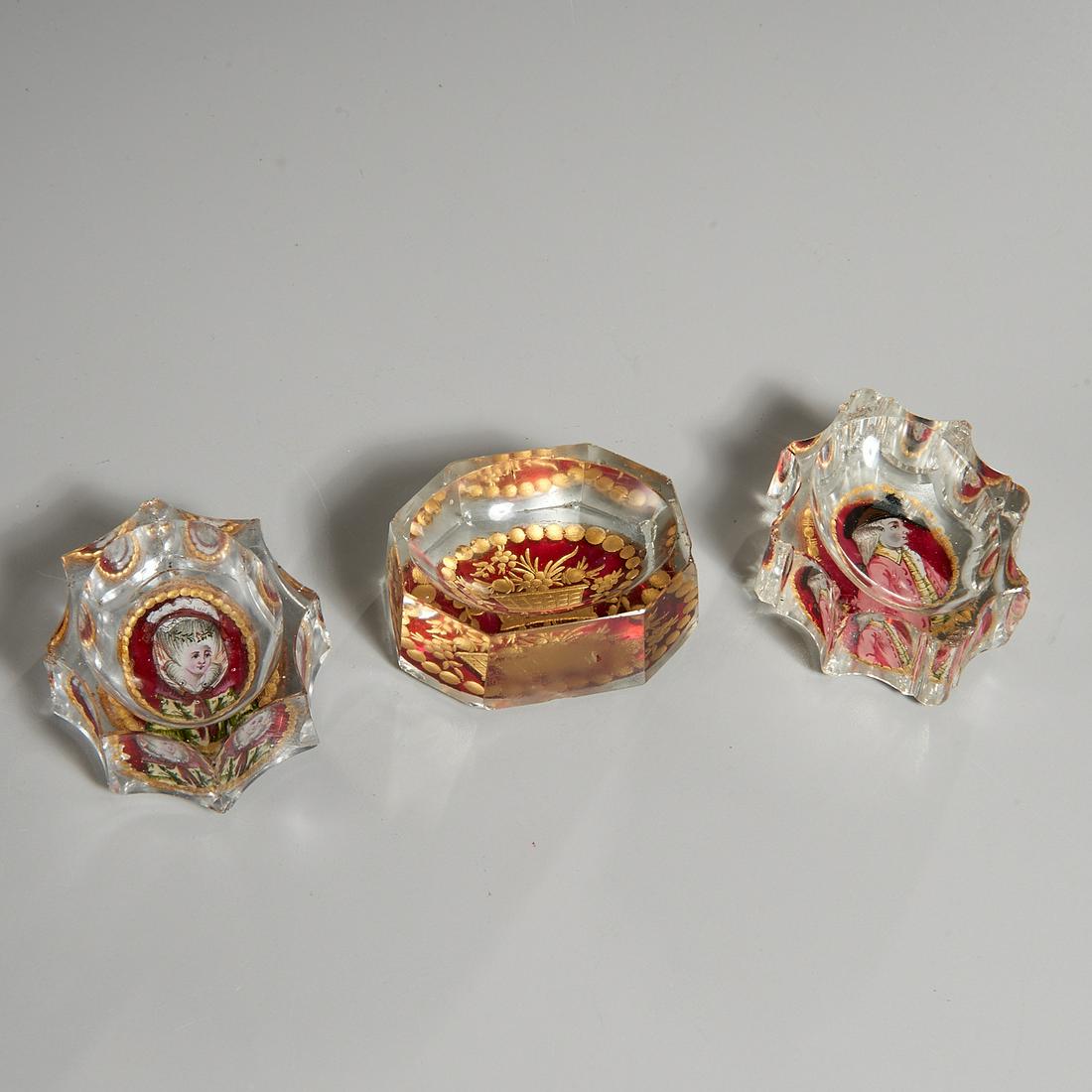(3) George III reverse-painted glass salt cellars: (3) George III reverse-painted glass salt cellars, 18th c., scalloped sides, central cut and reverse painted oval portrait cartouches, each 3" l Provenance: The Collection of Elizabeth "Betty" Seeler