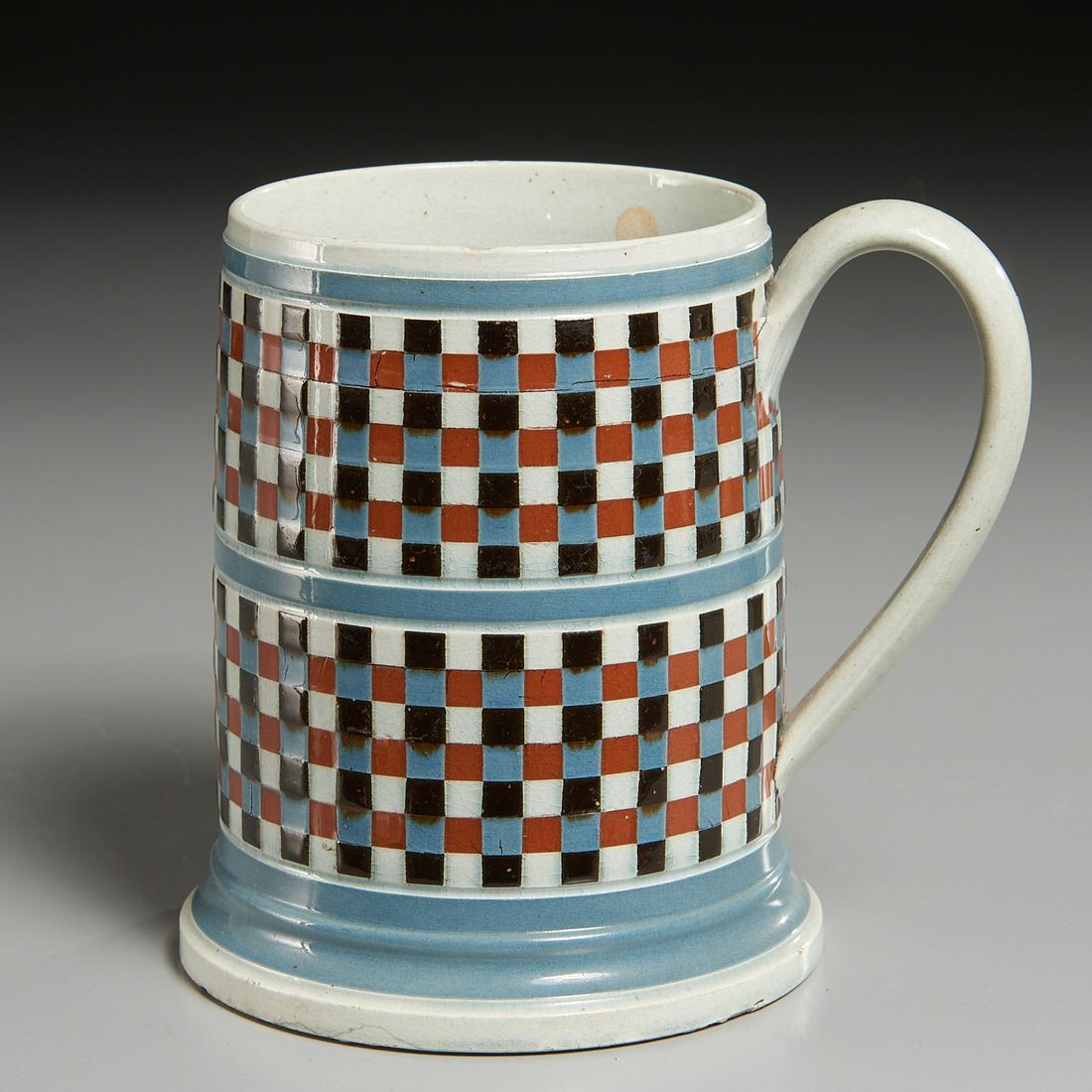 English Engine-Turned Mochaware Mug: English Engine-Turned Mochaware Mug, Early 19th c, decorated with two tiers of checkerboard decoration in colors of rust, black, white and blue separated by light-blue banding on cream ground, 6" h Pr