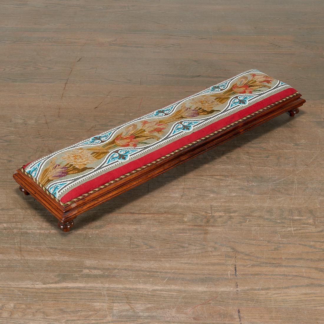 Victorian Needle and Bead-Work Long Footstool: Victorian Needle and Bead-Work Long Footstool, Mid-19th c., Urquhart & Adamson, Liverpool, the top applied with floral and scroll beadwork on a red damask ground, above a molded apron on toupie feet,