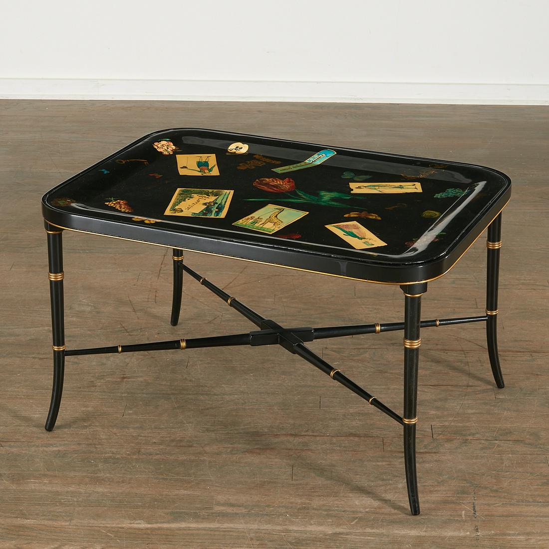 Fornasetti Style Enameled Tray on Table Base: Fornasetti Style Enameled Tray on Table Base, 20th c., the tray decorated with trompe l'oeil objects on an associated bamboo-turned black and gilt splayed leg stand, unmarked, 19" h x 31 1/4" w x 23 1
