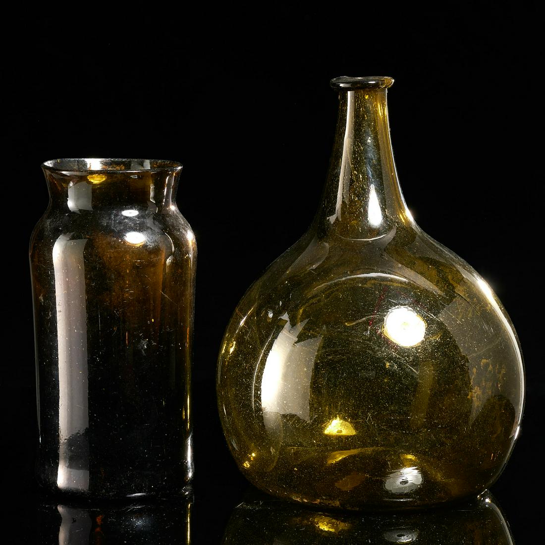 (2) Antique green glass apothecary vessels: (2) Antique green glass apothecary vessels, 19th c., hand-blown bottle and flask, with internal impurities, flaws and bubbles, vase: 8.75"h x 4.25"dia, flask: 11"h x 7.5"dia