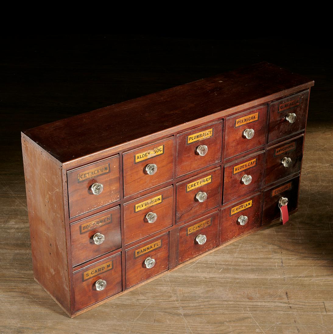 Antique 15-drawer apothecary cabinet: Antique 15-drawer apothecary cabinet, 19th c., possibly American, mahogany with glass knobs and painted paper labels incl. "Cetaceum" (obtained from the head of the sperm whale) on molded plinth base,