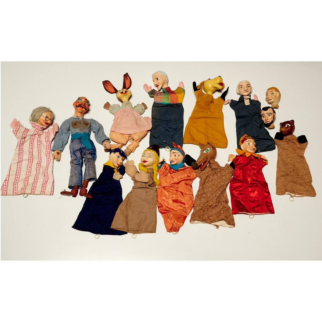 Collection (14) vintage hand puppets: Collection (14) vintage hand puppets, 20th c., group of hand painted papier-mache and cloth hand puppets, featuring Abraham Lincoln, George Washington, fox, rabbit, etc. each approx 22"h x 7"w x 2"d
