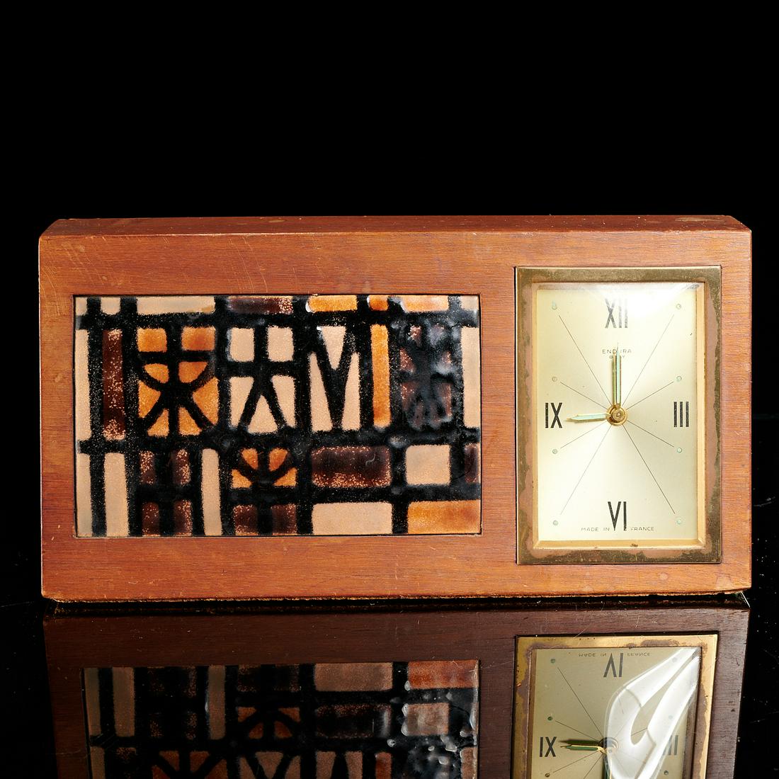 Mid-Century Modern teakwood and enamel table clock: Mid-Century Modern teakwood and enamel table clock, 20th c., by Endura, wind-up clock with fluorescent hands, enameled metal panel in the style of Roger Capron, 5.25"h x 10.5"w x 2.5"d