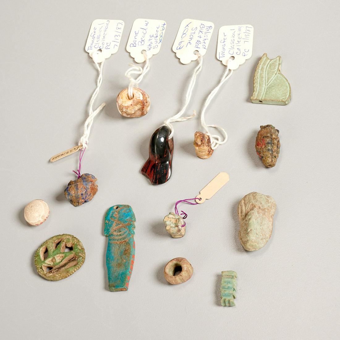 (13) Egyptian pendants, amulets, etc. ex-museum: (13) Egyptian pendants, amulets, etc. ex-museum, Possibly ancient, incl. a bone or shell bead, frog amulet, blue ceramic pharaoh pendant, polished black and red stone seal, bone (or stone) amulet base