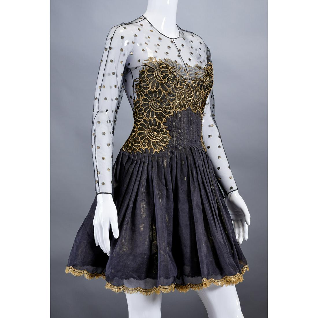 Geoffrey Beene black & gold cocktail dress: Geoffrey Beene black & gold cocktail dress, c. 1980's, retailed by Nan Duskin, black tulle and mesh outer layer with metallic gold floral and dot design, two layer underskirt, approx. 34"b, 21"sl, 37"