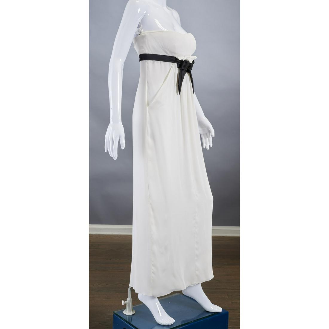 Valentino ivory gown with bow detail: Valentino ivory gown with bow detail, c. 1990's, strapless with black bow and ruffle at bust, draped & layered chiffon over silk jersey, (2) front pockets, approx. 34"b, 28"w, 54"l Provenance: From a 