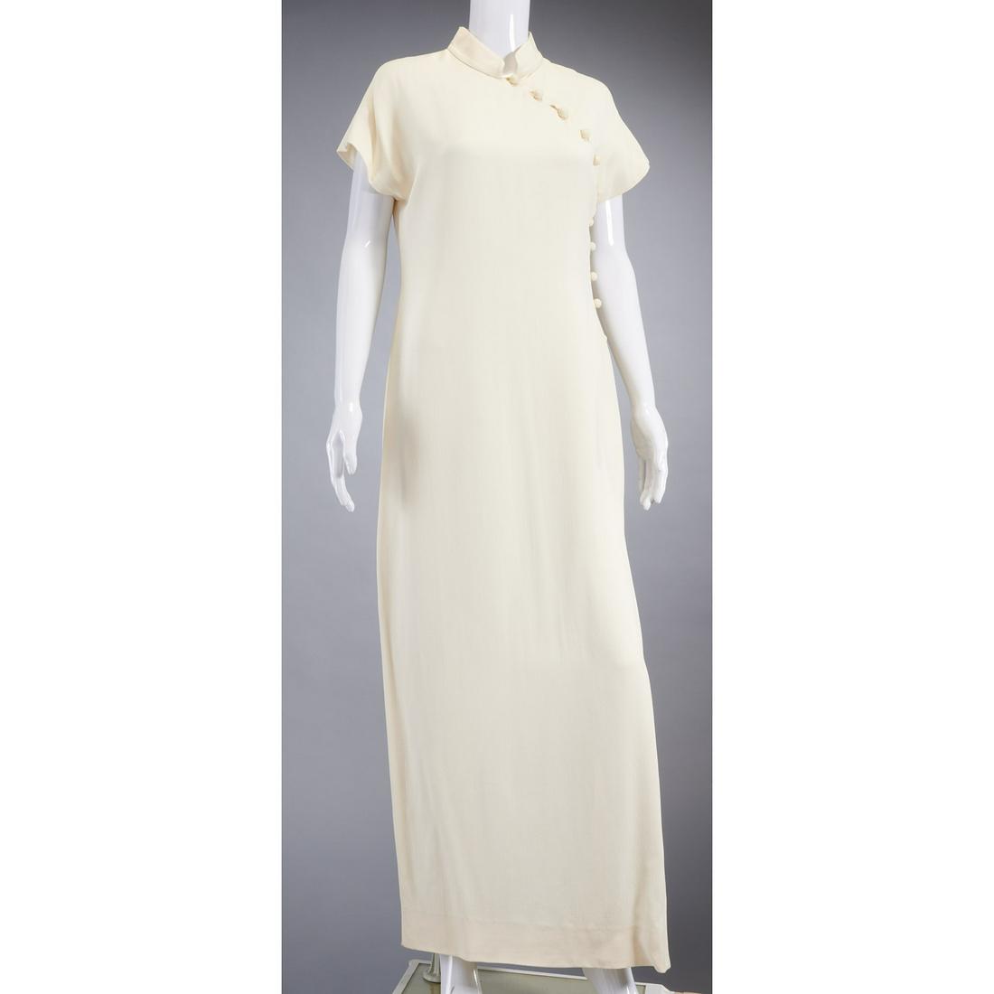 Bill Blass Asian style long column dress: Bill Blass Asian style long column dress, c. 1980's, with mandarin collar, side buttons at neckline, cap sleeves, side slit, ivory silk, fully lined, size 12, approx. 39"b, 57"l Provenance: From a pri