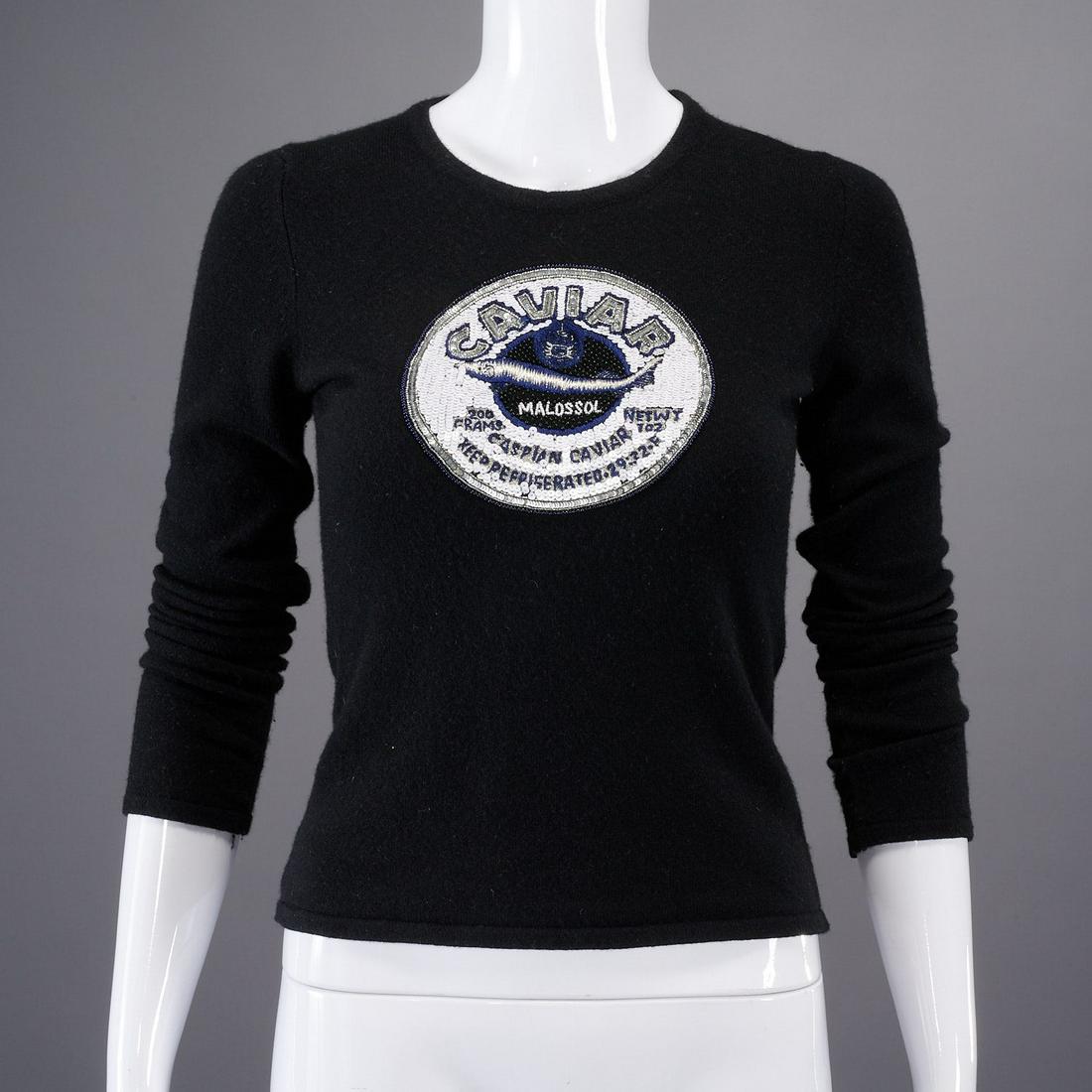 Queen of Cashmere "Caviar" sweater: Queen of Cashmere "Caviar" sweater, 21st c., ink navy, Made in Scotland, with sequin patch Caspian caviar medallion to center, approx. 33"b, 15"sh, 20"sl Provenance: From a New Canaan, CT single owner