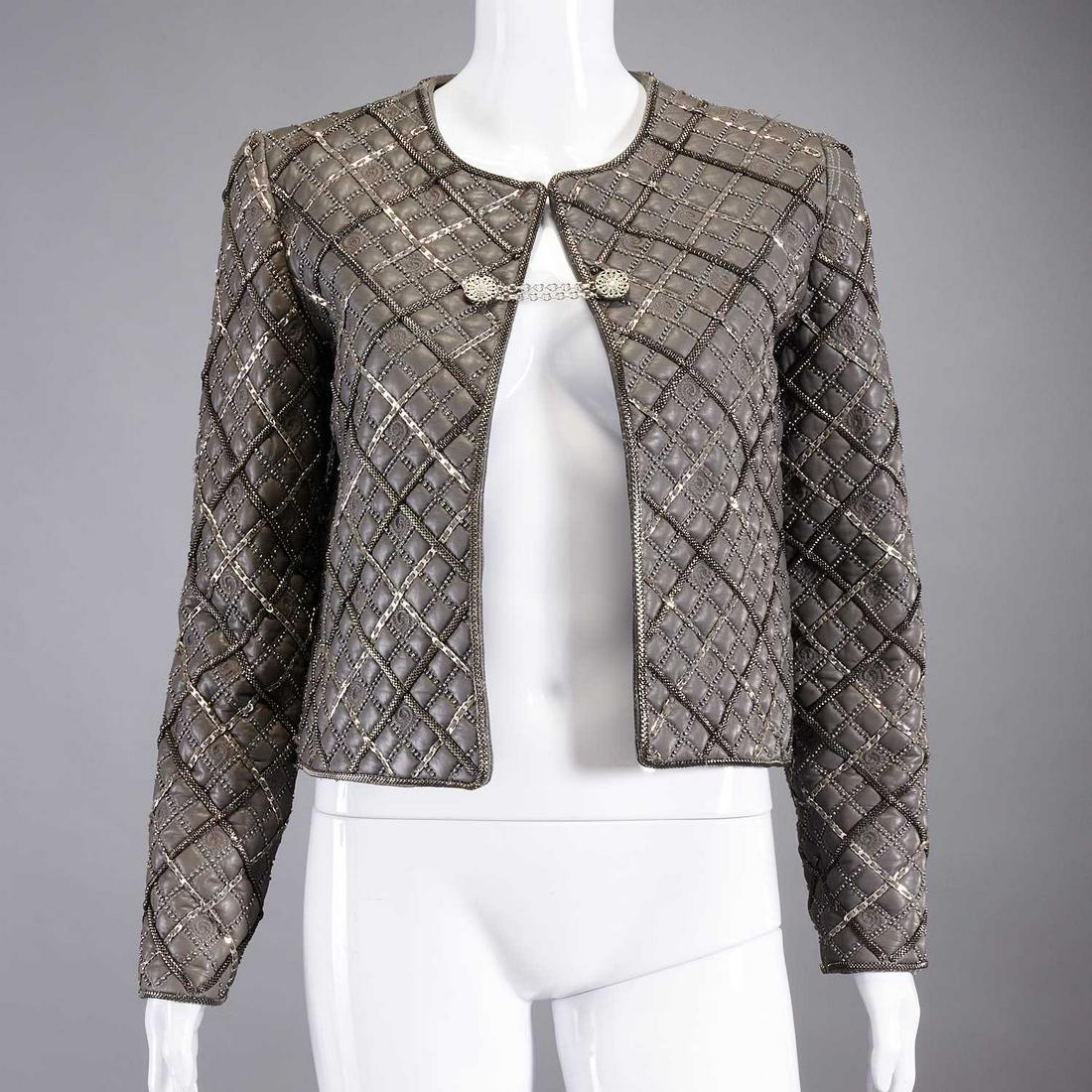 Oscar de la Renta embellished leather jacket: Oscar de la Renta embellished leather jacket, 2010 Fall collection, steel gray quilted leather with chain, stud & embossed detail, chain toggle closure, silk lined, size 4, approx. 38"b, 16"sl, 24"sl,