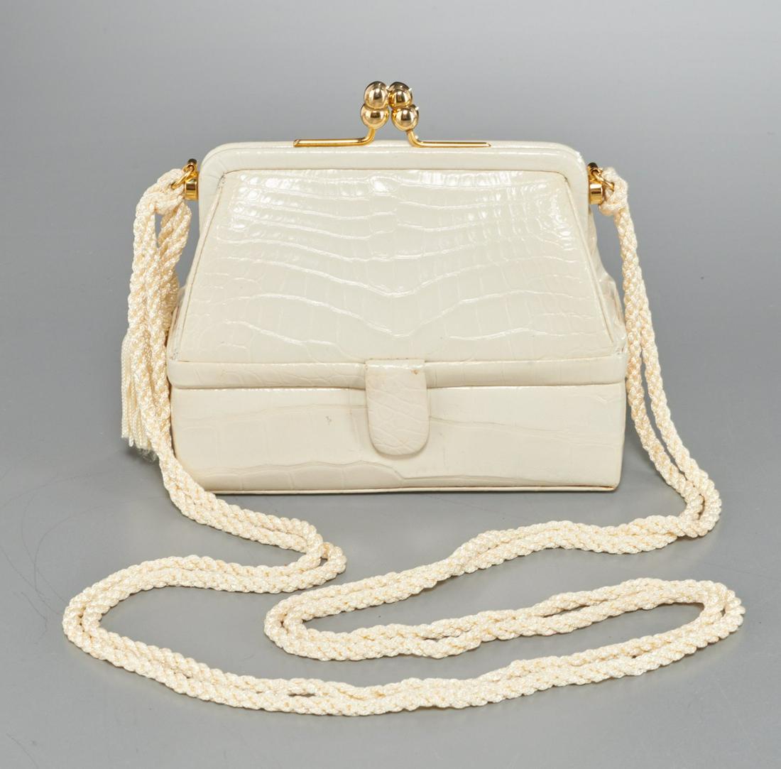 Vintage Judith Leiber 007 crocodile evening bag: Vintage Judith Leiber 007 crocodile evening bag, late 20th c., ivory with polished goldtone hardware, kiss lock closure, with removable woven shoulder strap with tassel detail, converts to clutch, hid