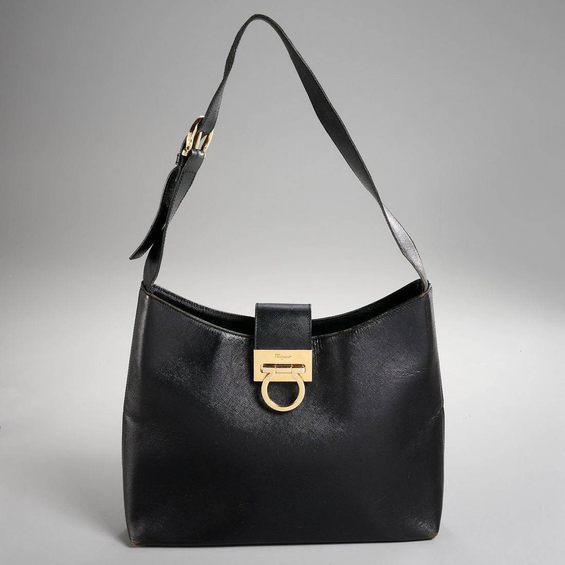 Salvatore Ferragamo leather shoulder bag: Salvatore Ferragamo leather shoulder bag, 20th c., single adjustable strap, gold-tone hardware, pull through lock closure at flap, stirrup buckle, interior in woven signature lining, (1) center compar