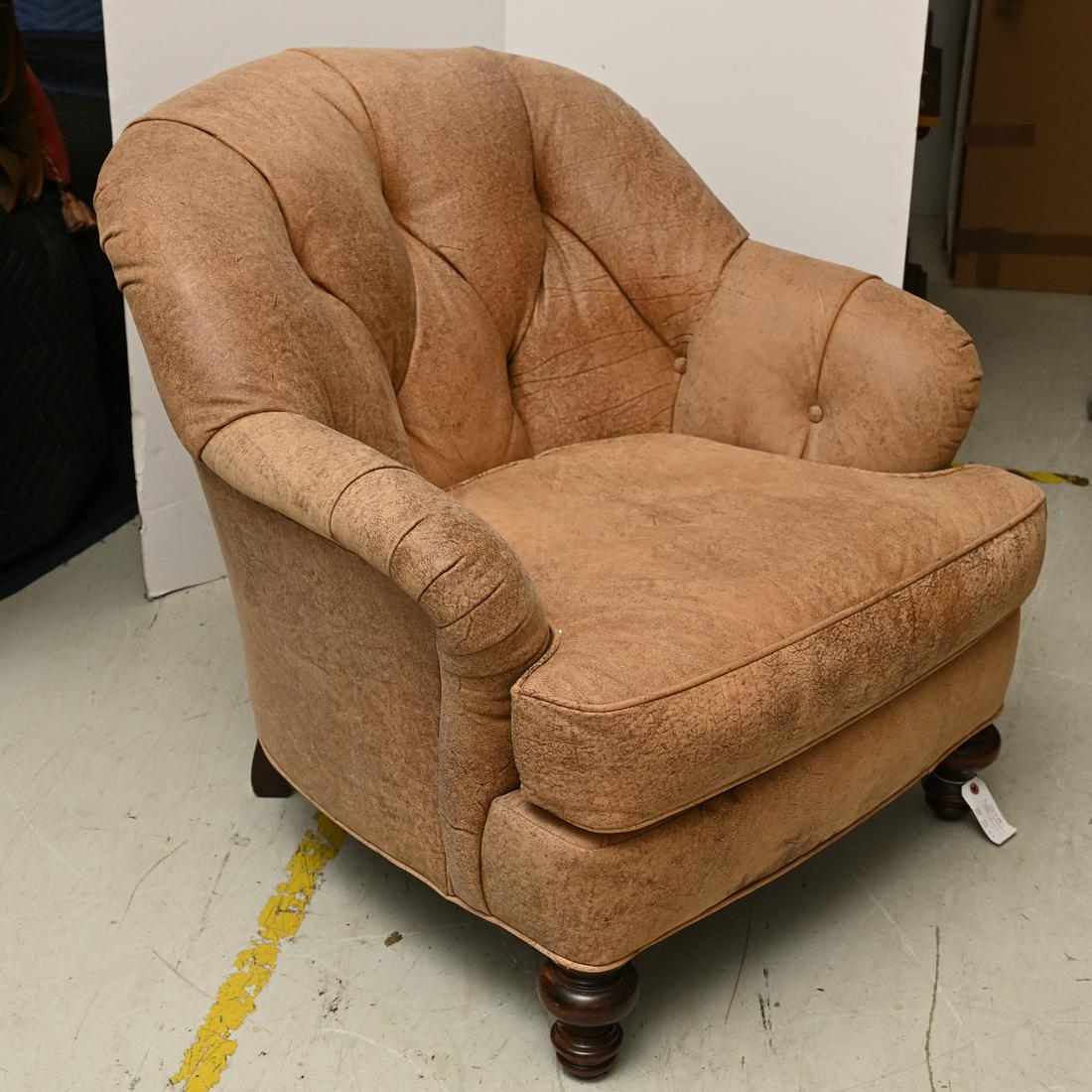 Whittemore-Sherrill tufted leather club chair: Whittemore-Sherrill tufted leather club chair, 20th/21st c., distressed leather upholstery with tufted back on turned wood front legs, label under seat cushion, 33"h x 31"w x 23"d