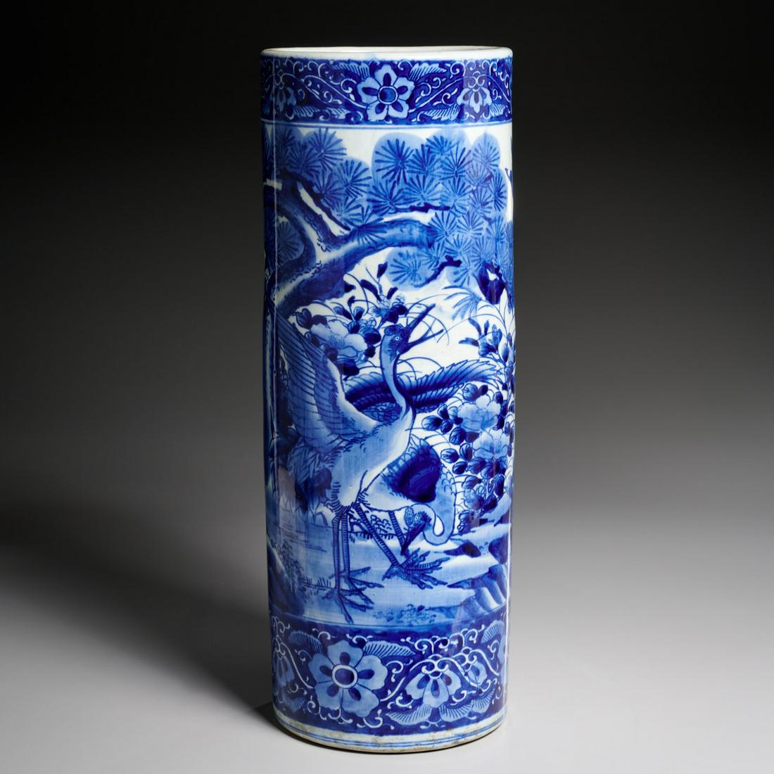 Japanese blue and white umbrella stand: Japanese blue and white umbrella stand, 19th/20th c., blue underglaze porcelain, decorated in the round with birds and trees and foliate border, 24"h x 8.5"dia Provenance: Property of a New York City 