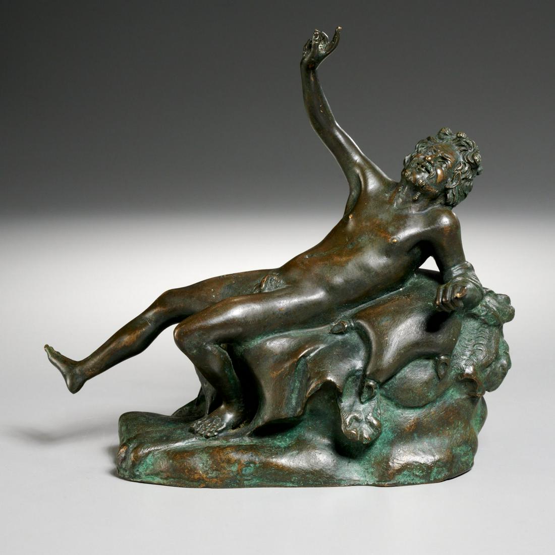 Grand Tour bronze of reclining Bacchus: Grand Tour bronze of reclining Bacchus, 19th c., Italian, dark and verdigris patinated bronze, depicting a figure reclining on a lion hide with a wine bladder by his side, after the antique, 8"h x 8"l