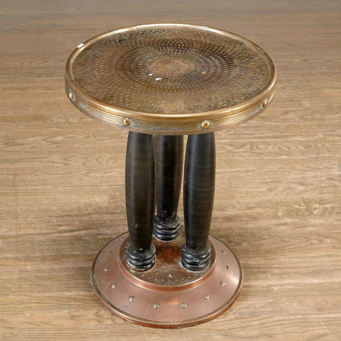 Jugendstil hammered metal occasional table: Jugendstil hammered metal occasional table, c. 1915, in the manner of Adolf Loos, tooled and hammered copper base and table top raised on three ebonized wood column supports, 26"h x 20"dia Provenance: