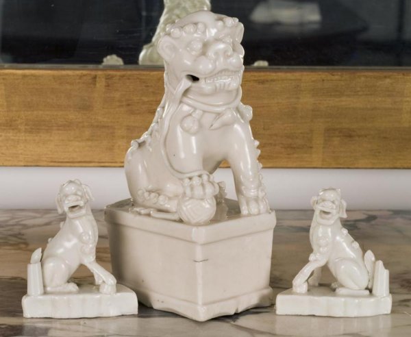 (3) antique Chinese blanc-de-chine porcelain joss s: (3) antique Chinese blanc-de-chine porcelain joss stick holders, Qing Dynasty, including one pair, in the form of a seated Buddhist lions on pedestals, larger: 7"h x 4"l x 2.75"d, smaller: 3"h x 2.5"l
