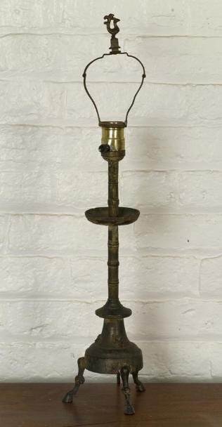 Chinese archaic Han style bronze lamp: Chinese archaic Han style bronze lamp, Possibly Han Dynasty, with turned stem on spreading base and hoof feet, electrified, 22.5"h x 5"dia. (total) Provenance: The Doris Duke Charitable Foundation