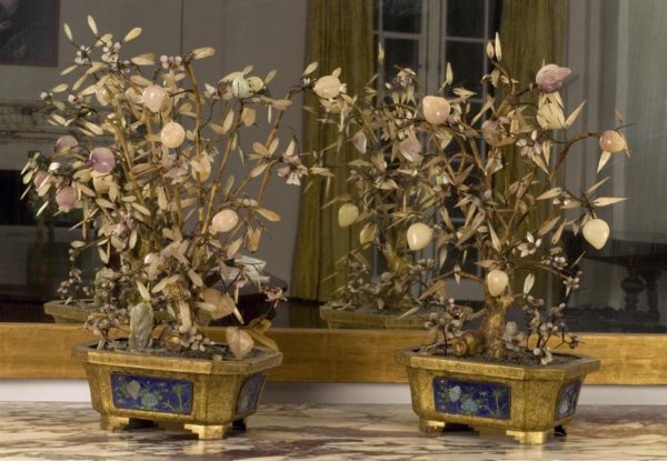 Pair antique Chinese jade fruit trees: Pair antique Chinese jade fruit trees, Qing Dynasty, each gilt trunk issuing pomegranate and peach hardstone fruit in cloisonne-paneled jardinieres, 22"h x 16"w x 8"d Provenance: The Doris Duke Charit