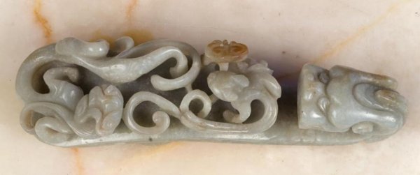 Antique Chinese carved green jade belt hook: Antique Chinese carved green jade belt hook, Qing Dynasty, carved with coiled chi dragons, 5"l x 1.25"w Provenance: The Doris Duke Charitable Foundation