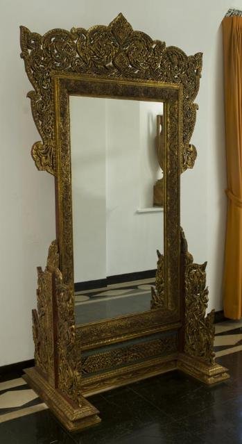 Antique Thai carved giltwood mirror on stand: Antique Thai carved giltwood mirror on stand, 19th/20th Century, the rectangular mirror plate with elaborate pierced Naga dragon cresting on similarly decorated trestle base, 95.5"h x 54"l x 31"d Prov