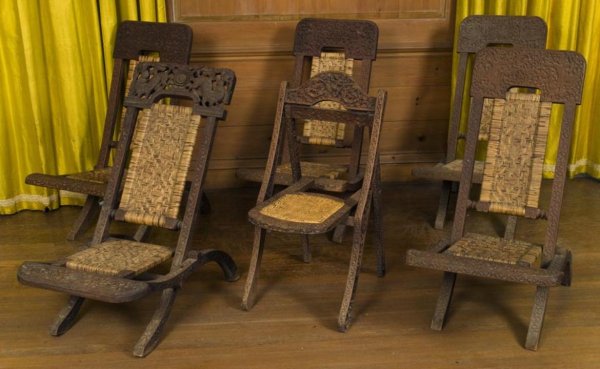 Group (6) antique Thai carved hardwood folding cha: Group (6) antique Thai carved hardwood folding chairs, 19th/20th Century, each with elaborately carved frames and caned seats, largest: 36.5"h x 20"w x 32"d, smallest: 33.5"h x 16"w x 22"d Provenance: