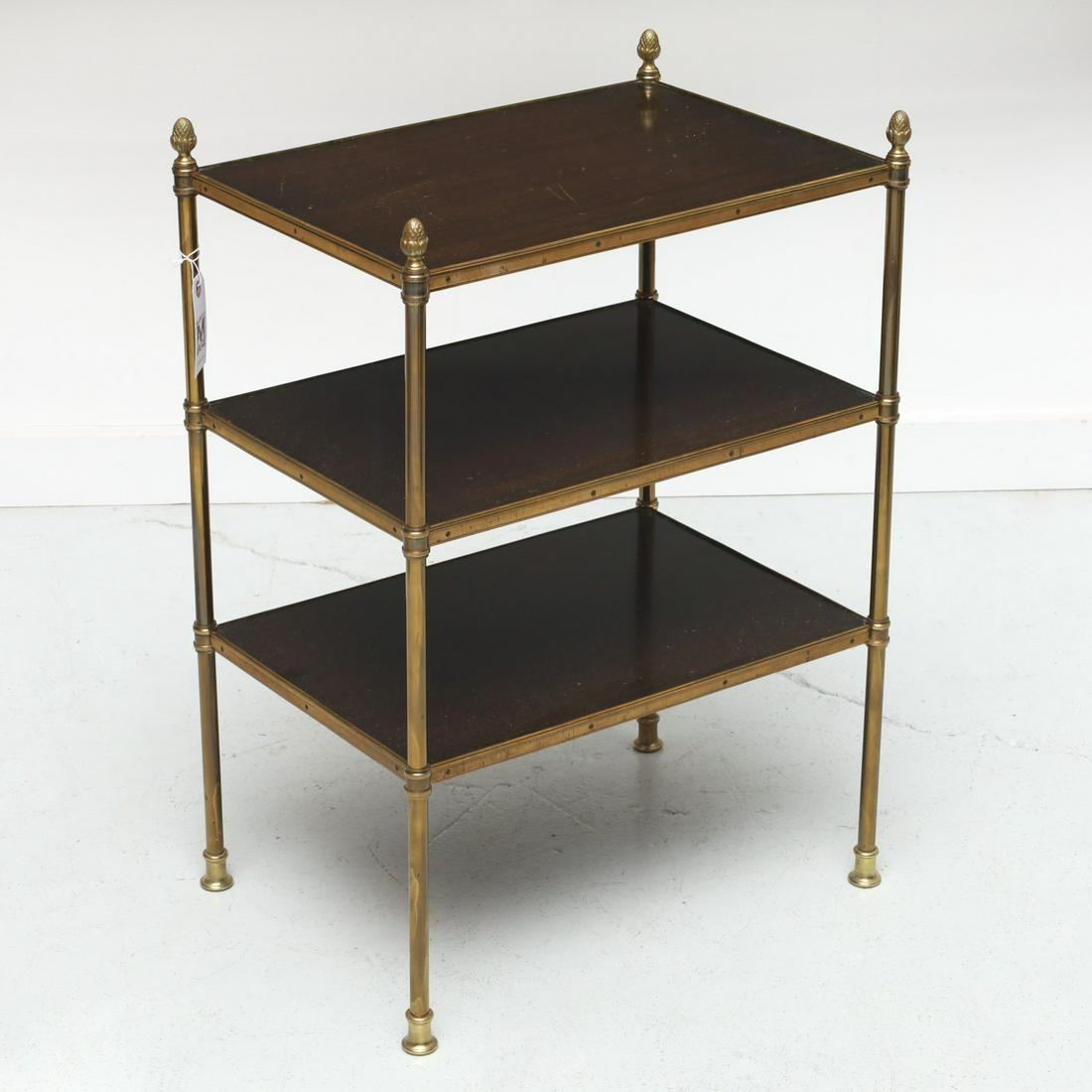 Mallett style brass, mahogany tiered side table: Mallett style brass, mahogany tiered side table, 20th c., brass legs, trim, and acorn finials, unmarked, 28.5"h x 19.75"w x 14"d Provenance: Property removed from 760 Park Ave, New York