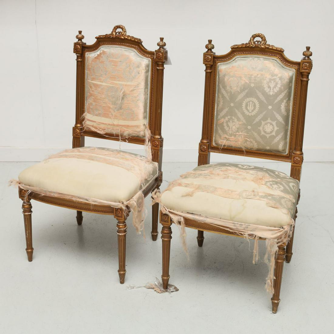 Pair antique Louis XVI style side chairs: Pair antique Louis XVI style side chairs, Late 19th c., France, gold painted carved wood frames decorated with a laurel back crest centered between floral orb finials, channeled pilasters sides and le