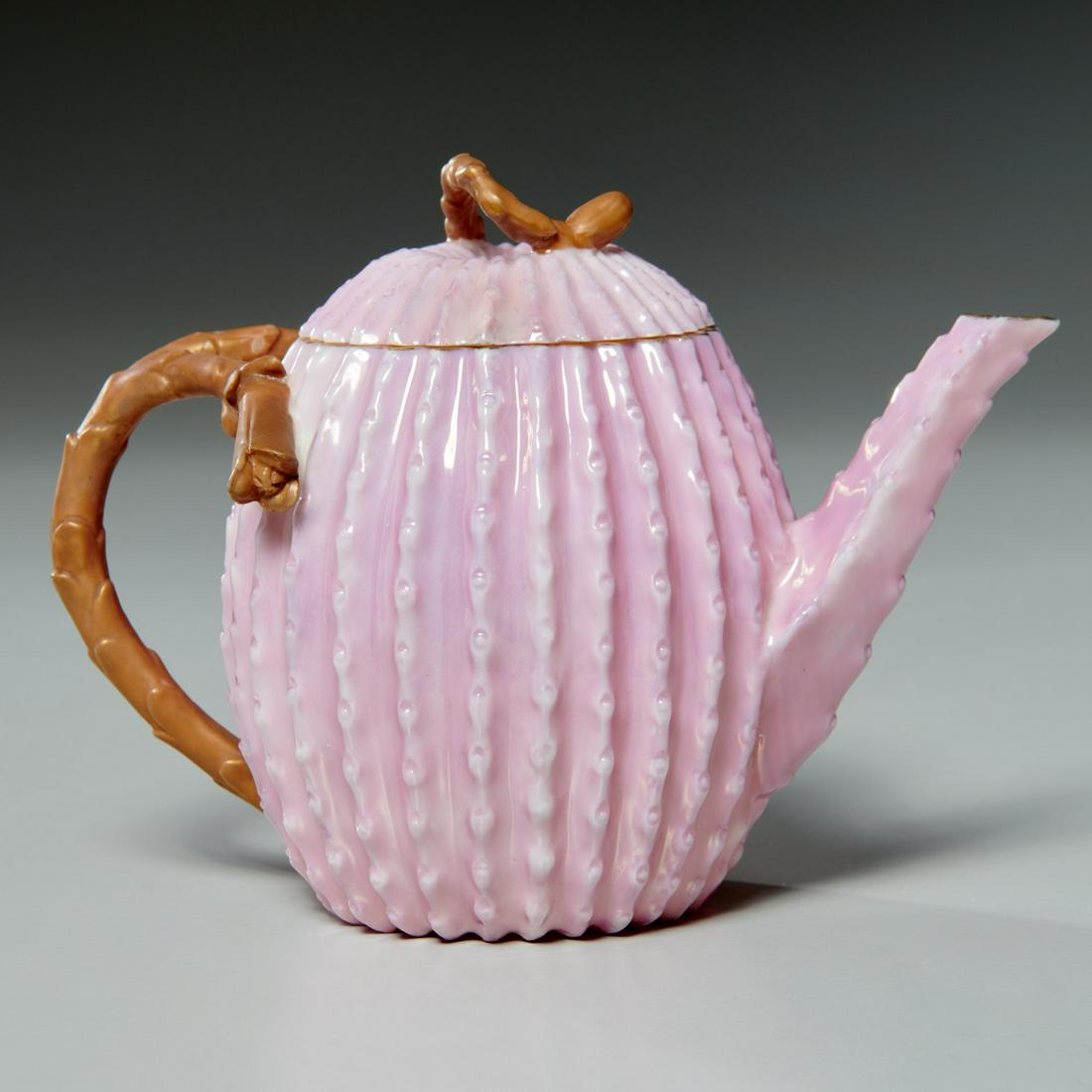 Ott & Brewer American Belleek porcelain teapot: Ott & Brewer American Belleek porcelain teapot, Late 19th c., pink cactus blossom delicate porcelain teapot with golden brown branch form handle and finial, 4.5"h x 6.25"w x 3.75"d Provenance: Acquire