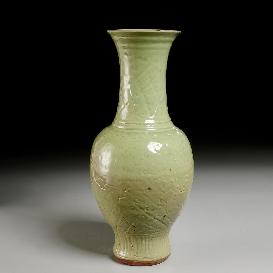 Chinese carved Longquan celadon Phoenix-tail vase: Chinese carved Longquan celadon Phoenix-tail vase, Ming Dynasty (1368-1644 AD), heavily potted sea-green glazed ceramic, relief carved with lotus scrolls around the body and crosshatching on the foot 