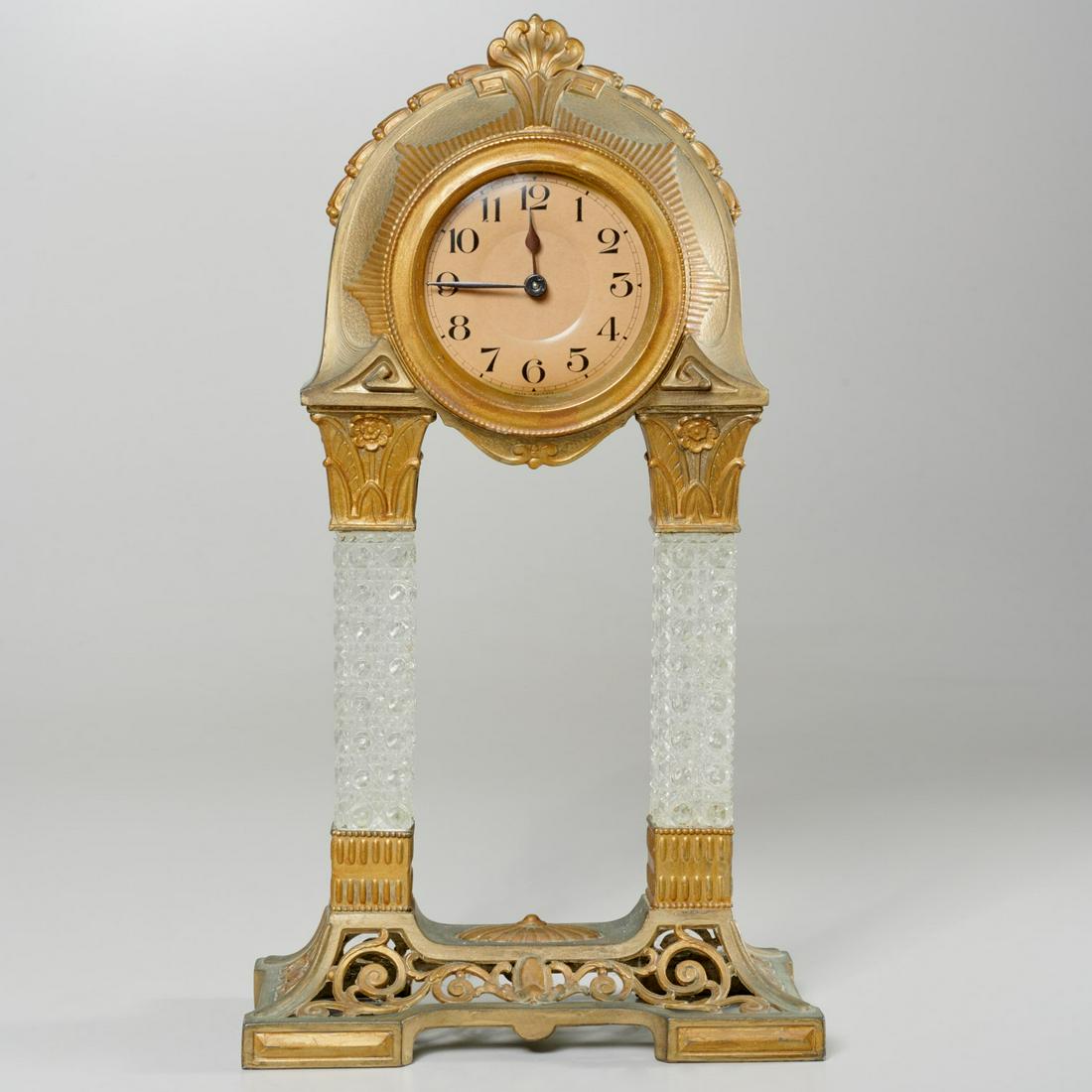 German Art Nouveau style portico clock: German Art Nouveau style portico clock, 20th c., with gilt metal case, pressed glass squared columnar supports, and openwork scrolled base, dial marked "Germany", 16.5"h x 9"w x 4.5"d