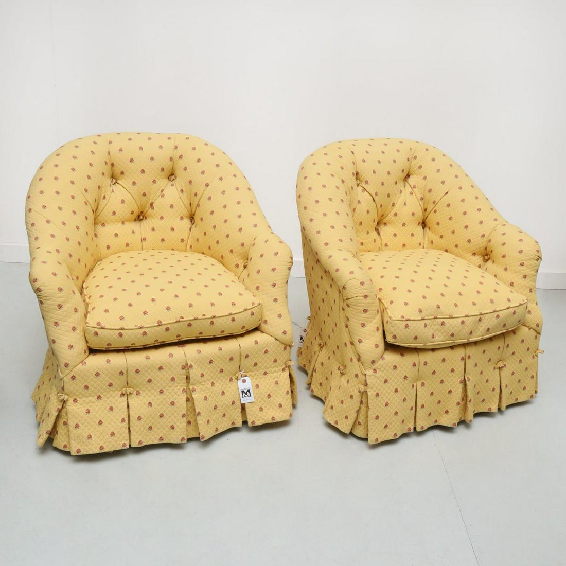 Pair custom upholstered swivel tub chairs: Pair custom upholstered swivel tub chairs, 20th c., in tufted, pleated, and skirted yellow fabric with delicate raspberry design, no visible marks, 32.5"h x 29"w x 26.5"d