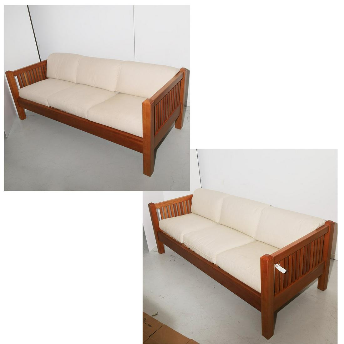 Pair Scott Jordan cherrywood sofas: Pair Scott Jordan cherrywood sofas, 21st c., contemporary slat back design, with removable seat and back cushions in textured cream fabric, metal placard label to frame, 29"h x 81.5"l x 35"d Provenanc