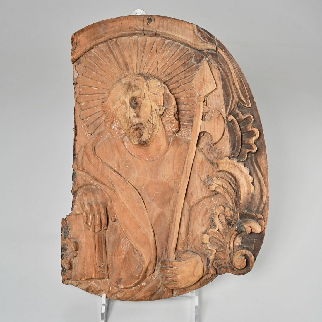 Italian carved wood relief plaque of a saint: Italian carved wood relief plaque of a saint, 17th/18th c., Saint Matthias with halo, holding book and axe, with border of scrolled foliates, fragmented carved wood plaque, likely limewood, 16"h x 11"
