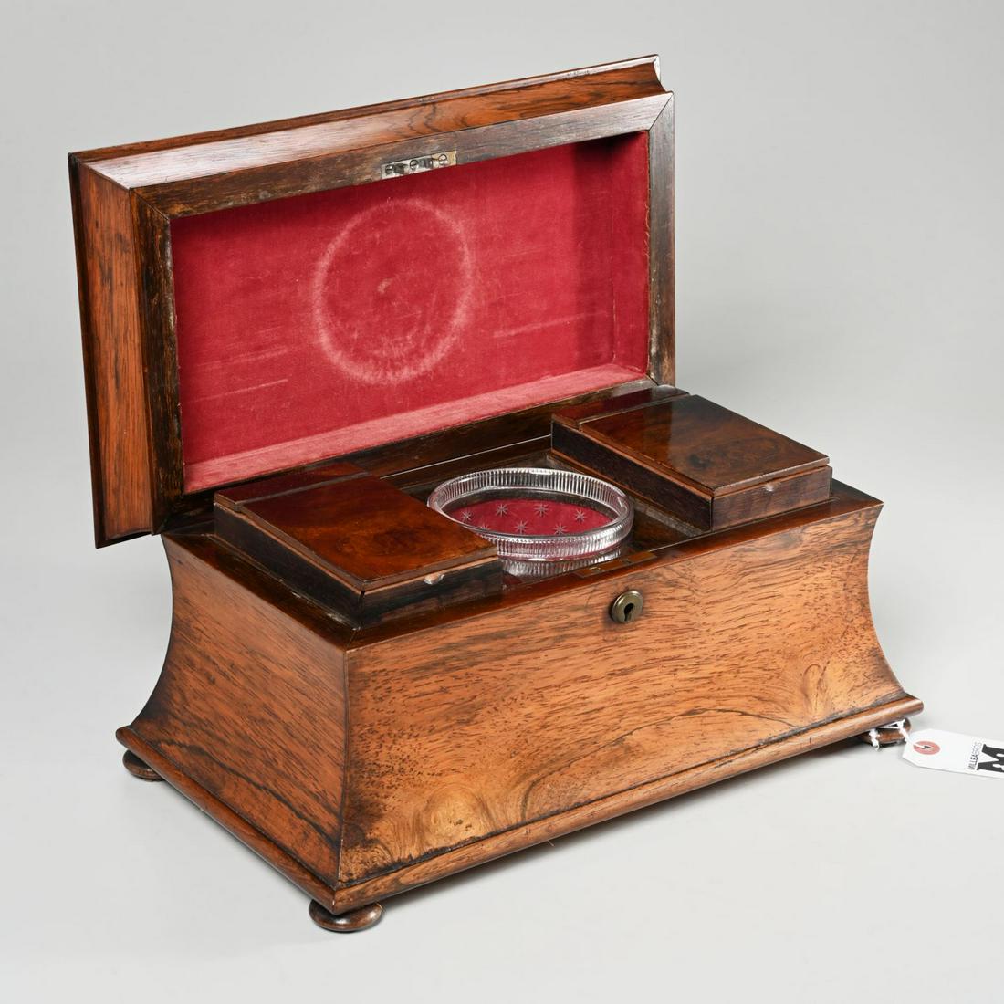 Large English Regency sarcophagus tea caddy: Large English Regency sarcophagus tea caddy, Eary 19th c., exotic wood caddy with hinged fabric lined lid, the interior with two foil lined lidded compartments flanking a circular cut-out fitted with 