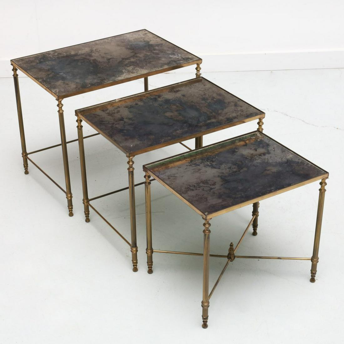 Set (3) Maison Jansen style nesting tables: Set (3) Maison Jansen style nesting tables, 20th c., each with inset smoky glass top, reeded columnar legs, the smallest with cross stretcher and flame finial, unmarked, 18"h x 21.5"w x 15"d (largest)