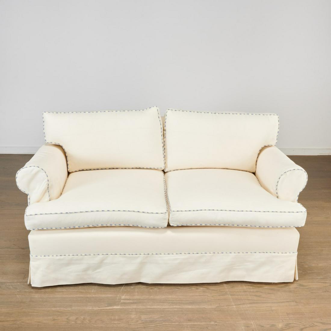 Custom white loveseat with gingham welting: Custom white loveseat with gingham welting, 20th/21st c., nice quality, with goose down cushions and skirted base, unmarked, 30"h x 59"w x 29.5"d Provenance: Property removed from 760 Park Ave, New Yo