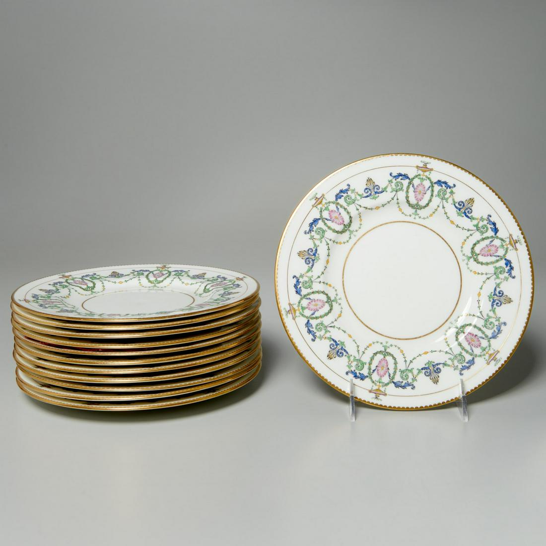 Set (12) Mintons Adam style luncheon plates: Set (12) Mintons Adam style luncheon plates, 20th c., English, pattern H2581, with Adam style enameled urn, swag, and scrolled foliage decoration to border, with gilt edge, "Mintons" maker's mark to u