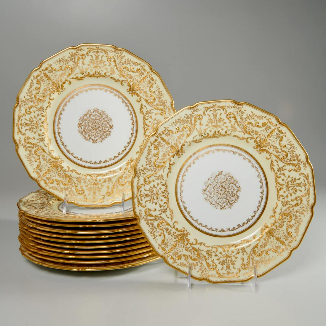 Set (12) Royal Doulton parcel gilt service plates: Set (12) Royal Doulton parcel gilt service plates, Late 19th/Early 20th c., English, porcelain dinner plates, with pale yellow banded border, scalloped edge, with gilt floral and vine decoration, incl