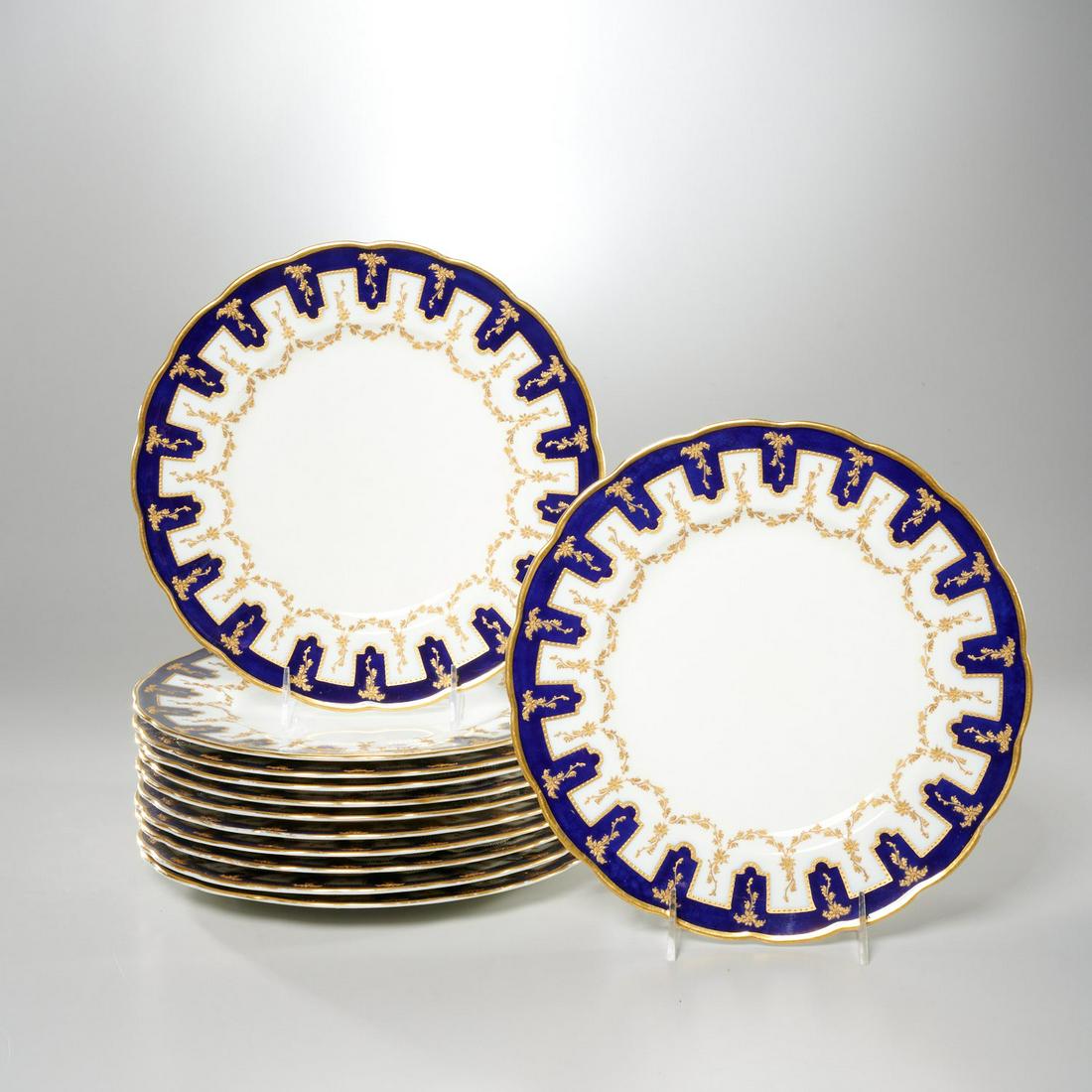 Set (12) George Jones & Sons dinner plates: Set (12) George Jones & Sons dinner plates, 20th c., English, porcelain dinner plates, having a cobalt border with slightly raised gilt floral decoration and gilt slightly scalloped edge, "George Jone