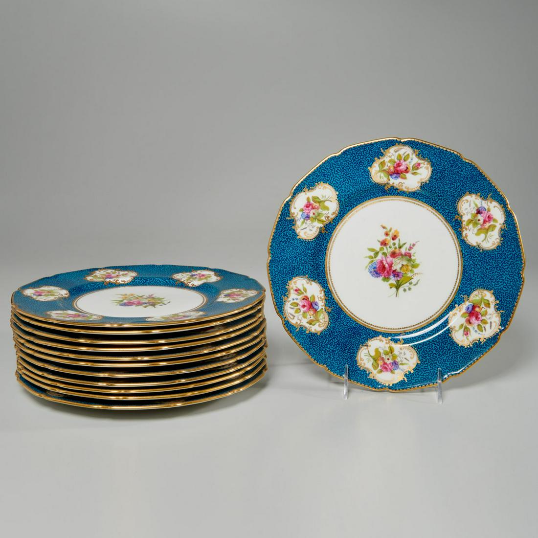 Nice set (12) Royal Doulton gilt floral plates: Nice set (12) Royal Doulton gilt floral plates, 20th c., English, porcelain cabinet (service) plates, having a floral bouquet to center, blue vermicule banded border, floral cartouches, and gilt scall