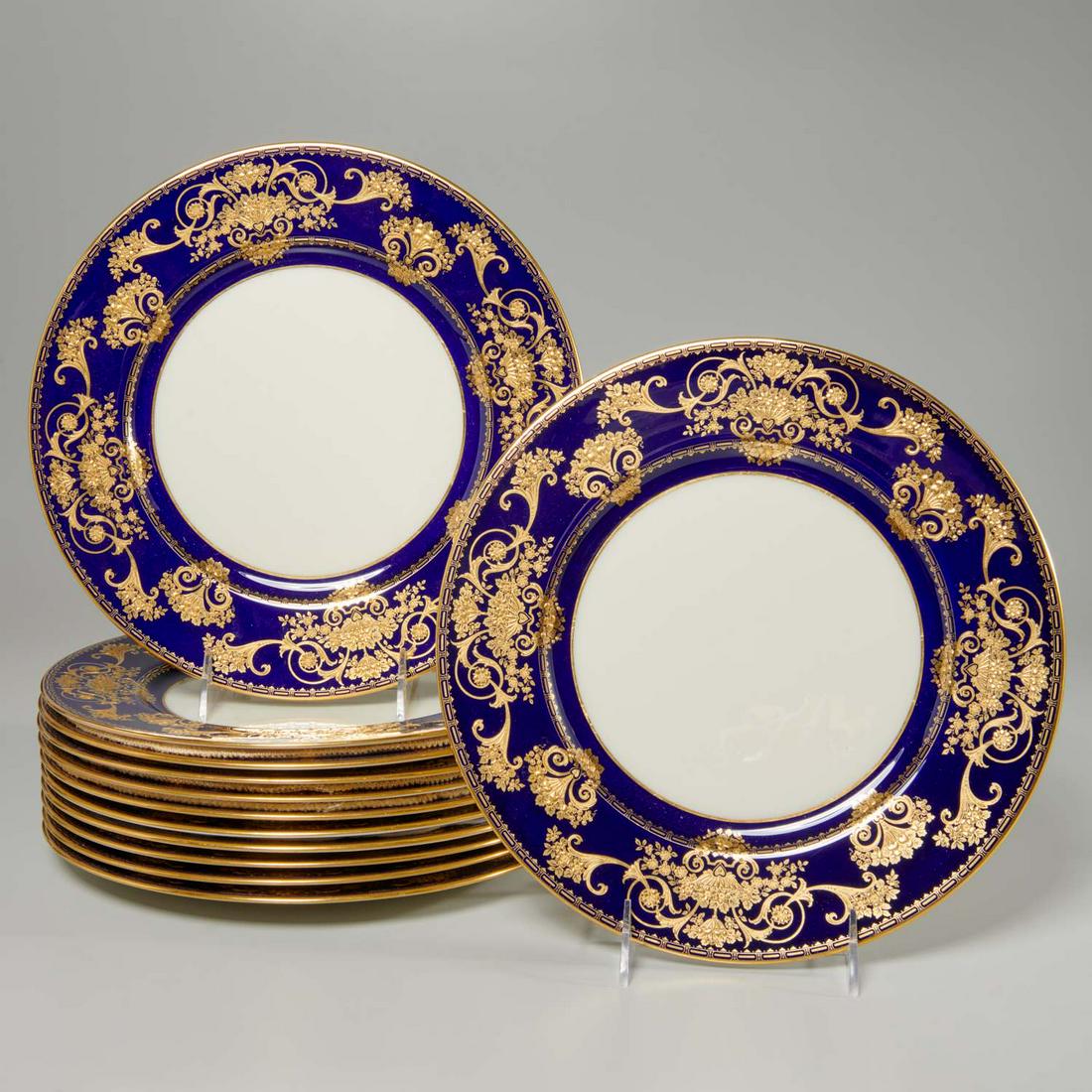Elegant set (12) Lenox gilt cobalt dinner plates: Elegant set (12) Lenox gilt cobalt dinner plates, c. 1906-1930, American, porcelain dinner plates, having a cobalt banded border, with raised gilt floral fruit basket and cornucopia decoration, "Lenox