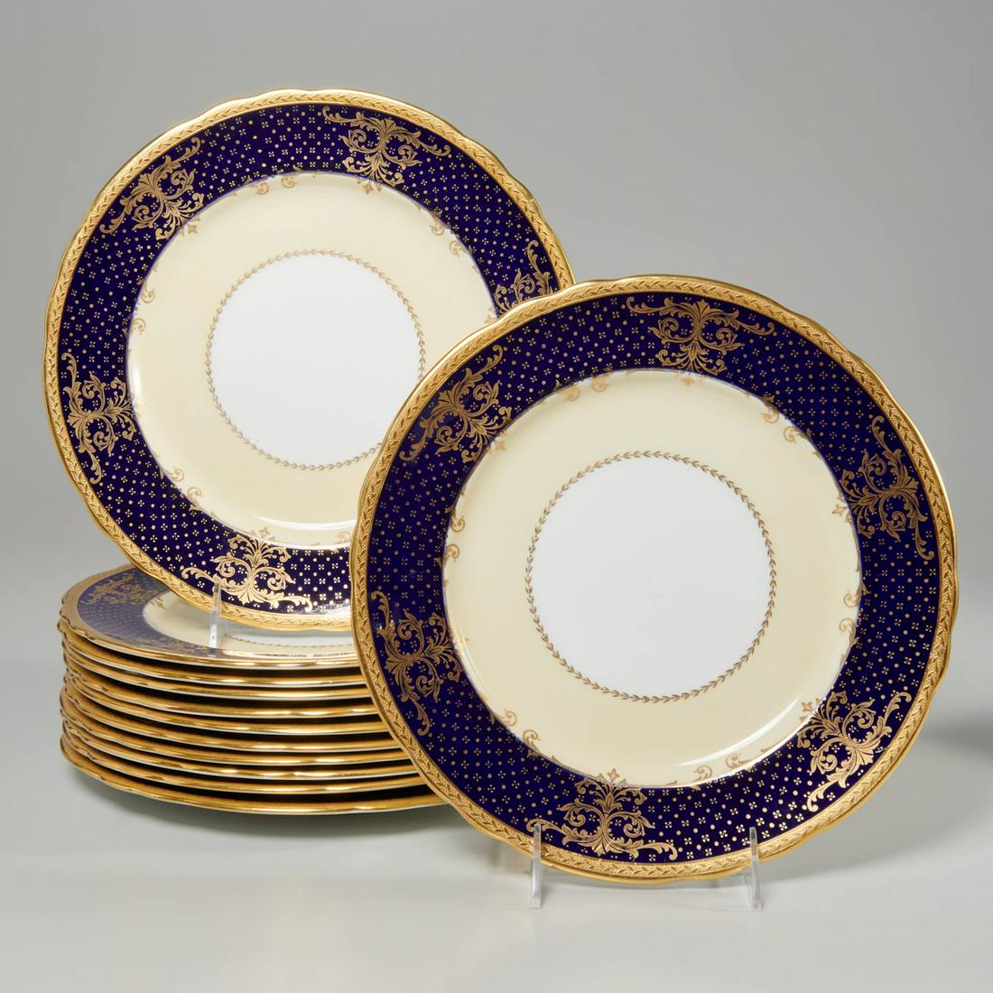 Set (12) Aynsley gilt cobalt plates: Set (12) Aynsley gilt cobalt plates, Mid 20th c., English, porcelain dinner (service) plates, having a cobalt banded border, with gilt scroll decoration, and gilt banding along slightly scalloped edge
