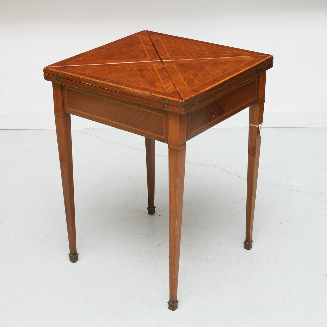 Louis XVI style parquetry envelope table: Louis XVI style parquetry envelope table, Late 19th/20th c., games table opens to a gold embossed green felt surface, on tapering square legs, 29.5"h x 21.25"squ. (closed), 42.75"w (open)