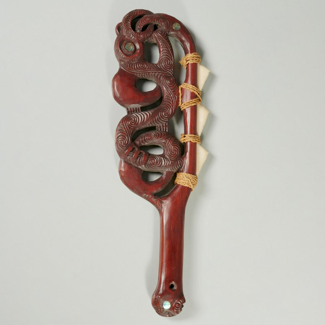 Maori style carved wood patu war club: Maori style carved wood patu war club, 20th c., with inlaid abalone shell details, 13.5"l x 4.5"w