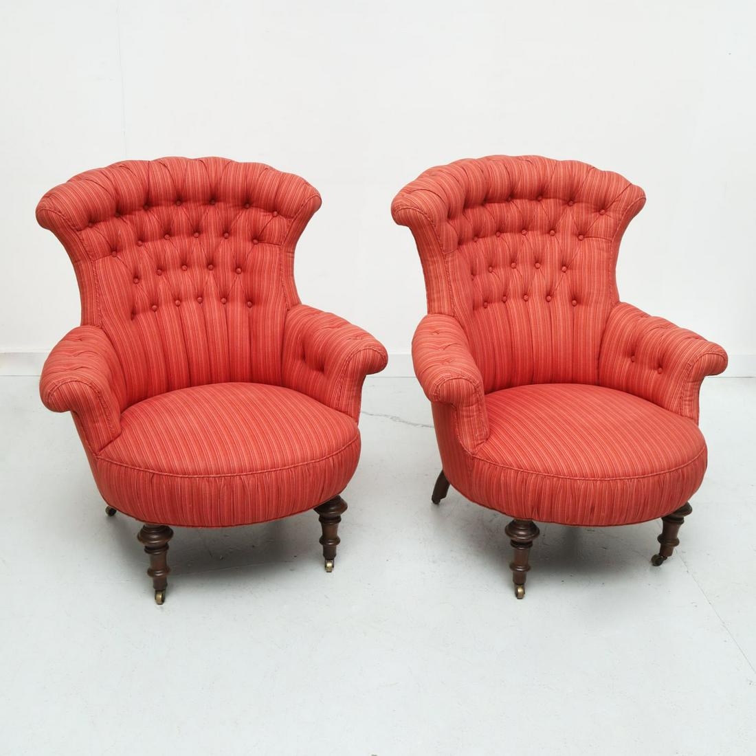 Pair Victorian custom upholstered armchairs: Pair Victorian custom upholstered armchairs, 19th c., nice pair cranberry upholstered chairs, with scrolled button tufted backs and arms, on turned wood legs, ending on casters, unmarked, 35"h x 32"w 