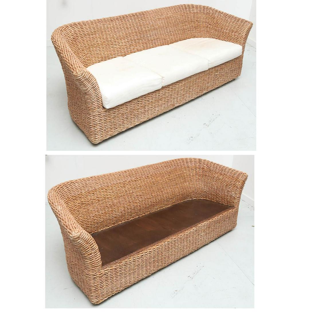 Pair Ralph Lauren style curved woven rattan sofas: Pair Ralph Lauren style curved woven rattan sofas, 20th c., three seat sofas, with cream fabric cushion back and seat, cushions with Pier One labels, 29.5"h x 79.5"w x 32"d