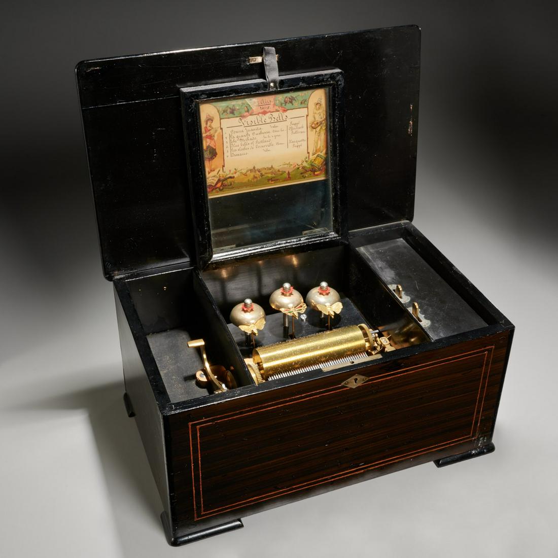 Swiss hardwood inlaid cylinder music box: Swiss hardwood inlaid cylinder music box, 19th c., marquetry case, brass cylinder and three bells each with winged butterfly strike, single comb, labeled with 6 aire song list, 9"h x 16"w x 10"d (case